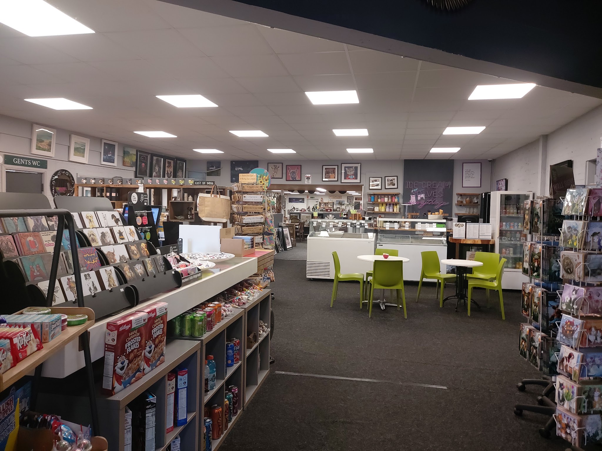 A wide view inside the shop, from the greeting cards and gifts to the coffee shop tables