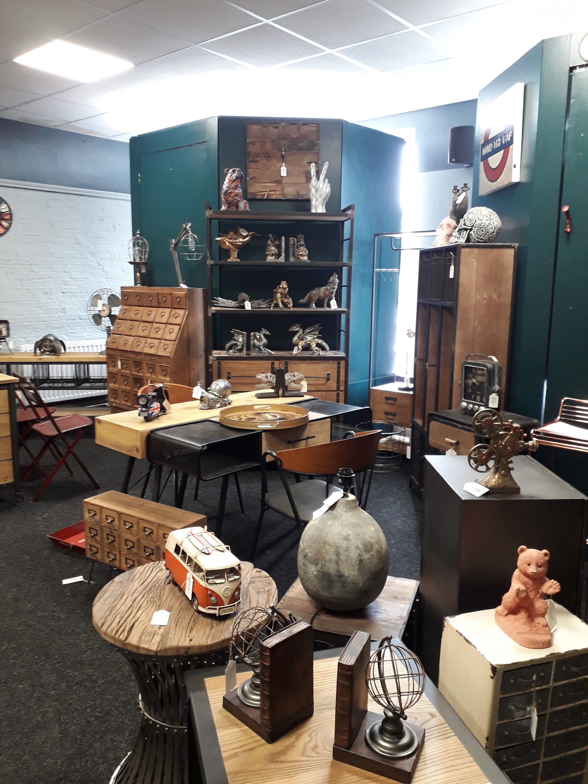 Curios, ornaments, vintage cabinets and a model camper van displayed in the shop